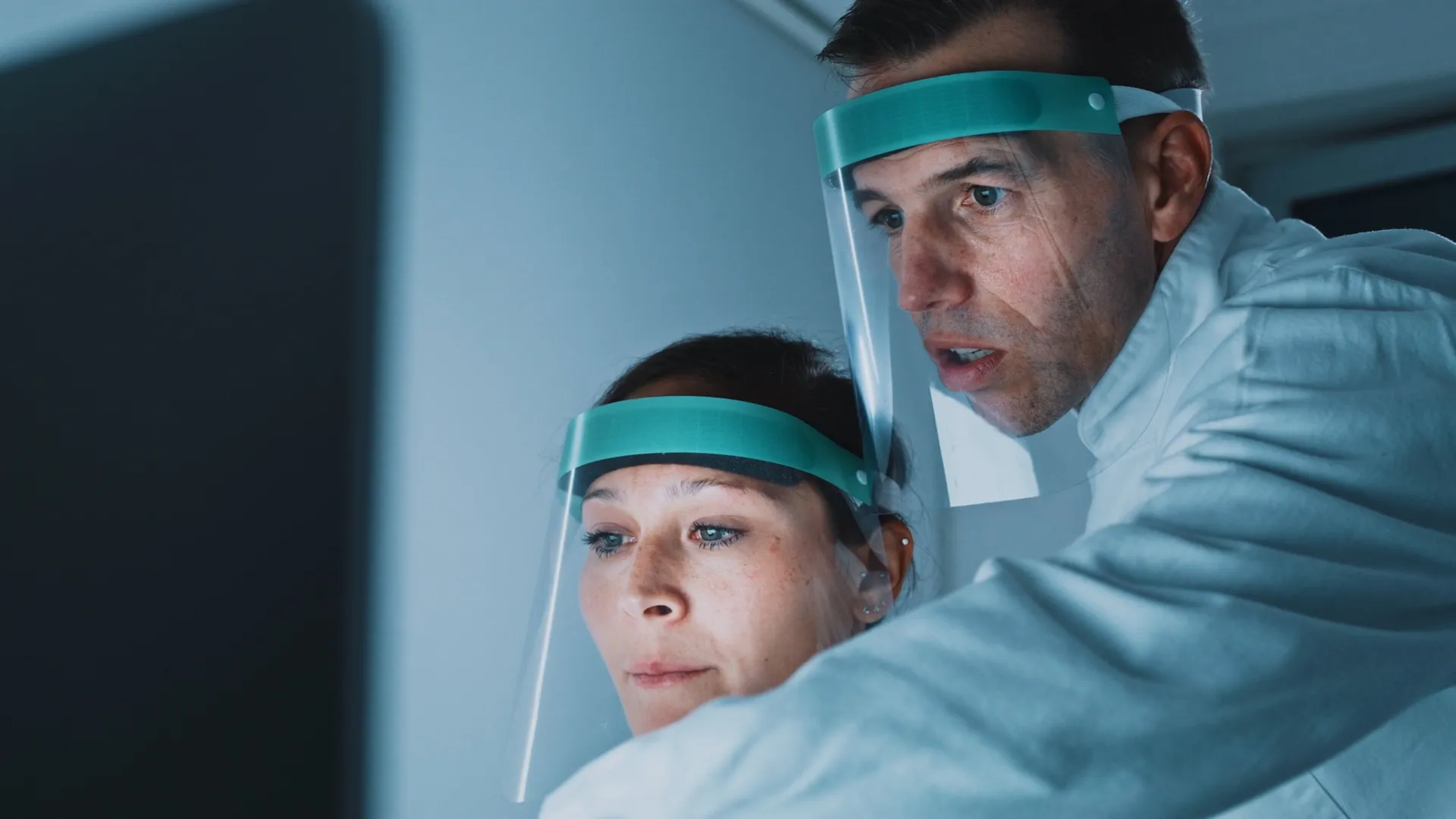 microbiologist and doctor looking at Solu's software on their screens